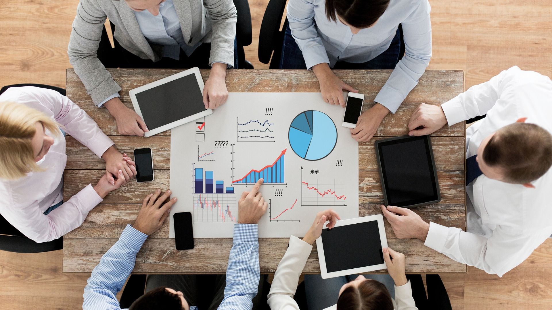 Overhead view of group of people sitting around a table working on a project