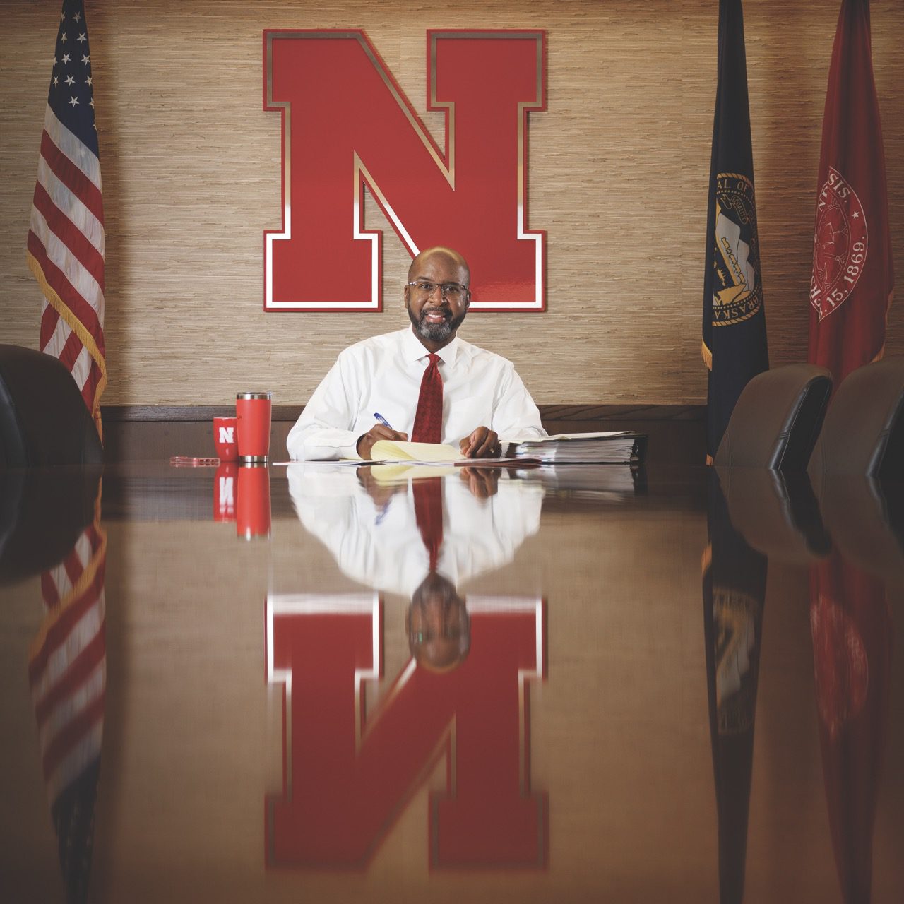 UNL Chancellor Rodney Bennett sits at end of long table.